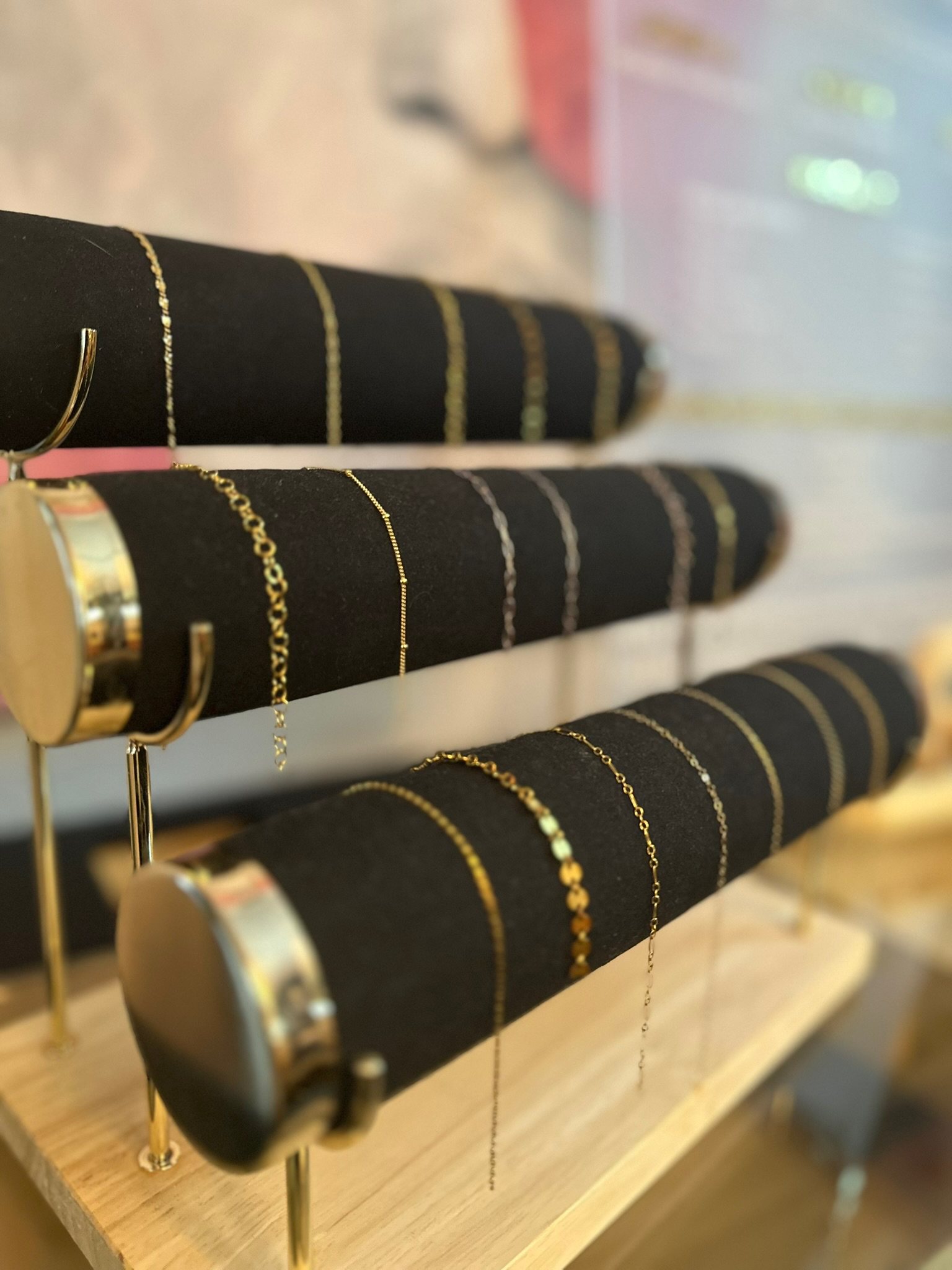 Cover, stacked gold-filled welded bracelets on the wrist — The Bronze Lily, St. Petersburg, FL