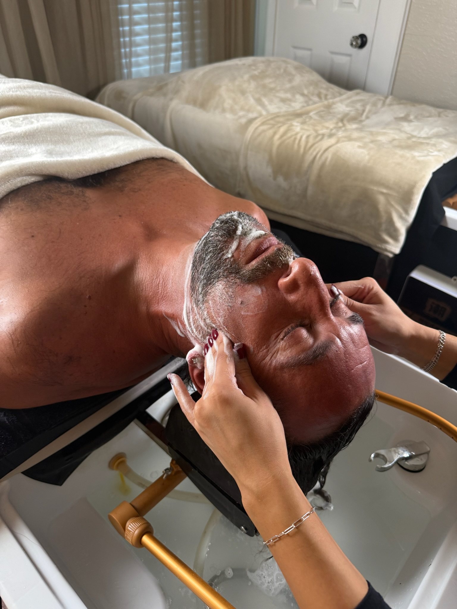 Head spa + beard treatment on a male client, relaxed, gift-worthy — The Bronze Lily, St. Petersburg, FL